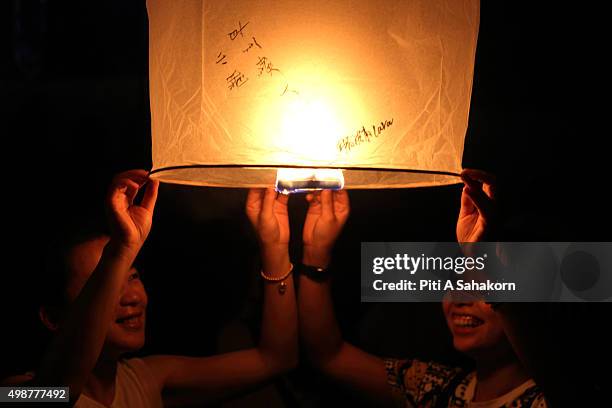 Tourists gather to release Khom Loi during the Yi Peng Festival outside the Lanna Dhutanka Temple in Chiang Mai. The Lanna Kathina Ceremony takes...