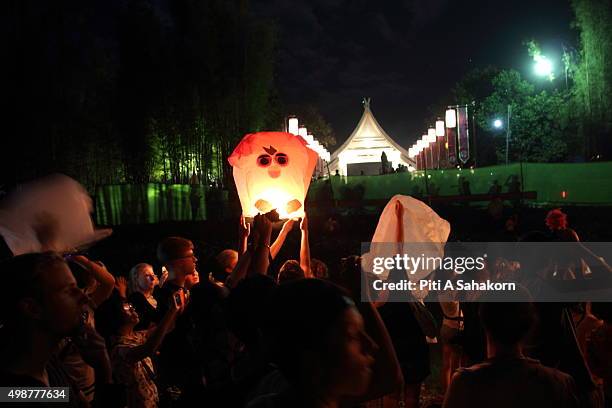 Tourists gather to release Khom Loi during the Yi Peng Festival outside the Lanna Dhutanka Temple in Chiang Mai. The Lanna Kathina Ceremony takes...