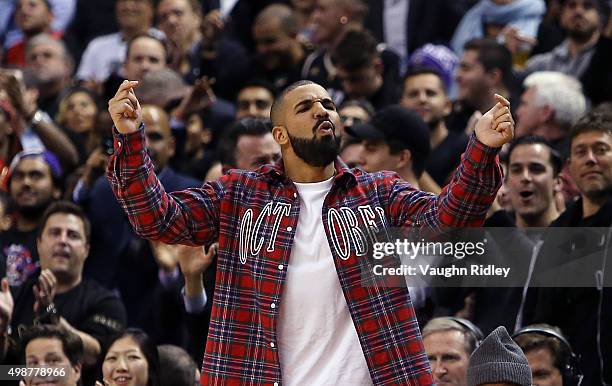 Singer Drake celebrates a Raptors score on 'Drake Night' during an NBA game between the Cleveland Cavaliers and the Toronto Raptors at the Air Canada...