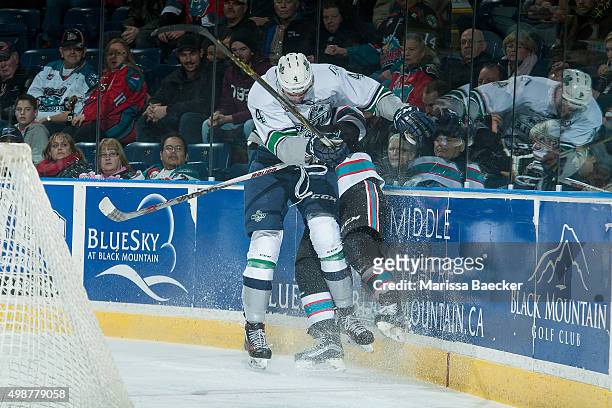 Turner Ottenbreit of Seattle Thunderbirds checks a player of the Kelowna Rockets into the boards during first period on November 25, 2015 at Prospera...