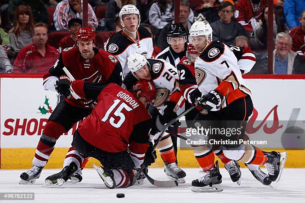 Boyd Gordon of the Arizona Coyotes wins a face-off against Mike Santorelli of the Anaheim Ducks, as Kyle Chipchura and Andrew Cogliano follow the...