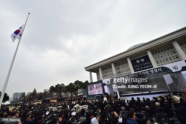 The South Korean national flag at half-mast flutters during a state funeral ceremony for the late former South Korean president Kim Young-Sam at the...