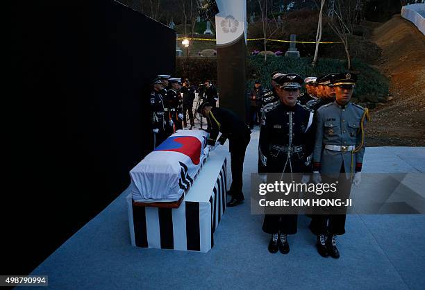 Military official adjusts a national flag covering the coffin of the late former South Korean president Kim Young-Sam during his burial ceremony at...