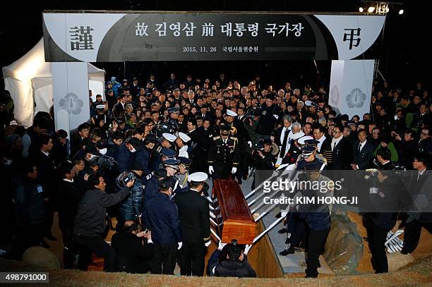 An honour guard lay the coffin of the late former South Korean president Kim Young-Sam during his burial ceremony at the national cemetery in Seoul...