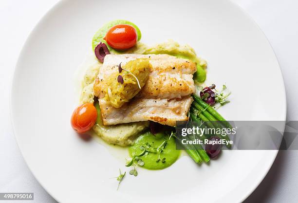 overhead view of healthy and delicious grilled fish restaurant dish - hoofdgerecht stockfoto's en -beelden