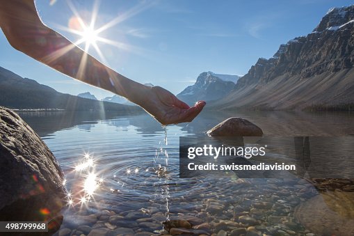Human hand cupped to catch the fresh water from lake Human hand cupped to catch the fresh water from lake