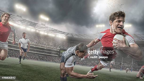 giocatore di rugby punteggi in eroica dive durante una partita di rugby - placcare foto e immagini stock