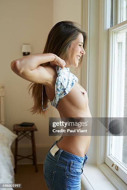 young woman flashing breasts out of window - female flasher stock pictures, royalty-free photos & images