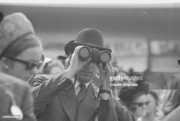 Lord Rosebery looking through binoculars at Goodwood Racecourse, Sussex, July 28th 1964.