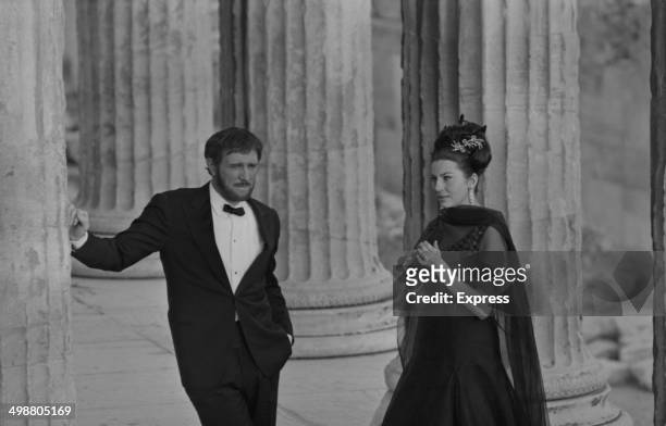 Actor Richard Harris and Princess Soraya of Iran, filming next to ancient ruins, 1964.