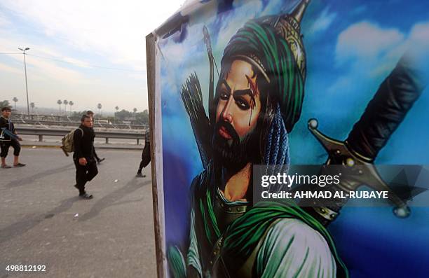 Shiite Muslim pilgrims walk on a highway in Baghdad's Dora district on November 26, 2015 on their way to the holy city of Karbala in central Iraq,...