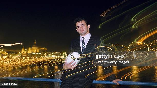 England rugby player Will Carling poses with a floodlit backdrop of St Pauls Cathedral and the City of London in 1988.