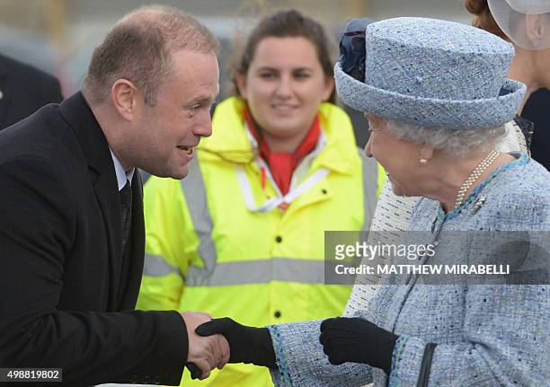 Queen Elizabeth II is welcomed by Malta's Prime Minister Joseph Muscat upon her arrival for a three-day visit in Malta, on November 26, 2015. Queen...