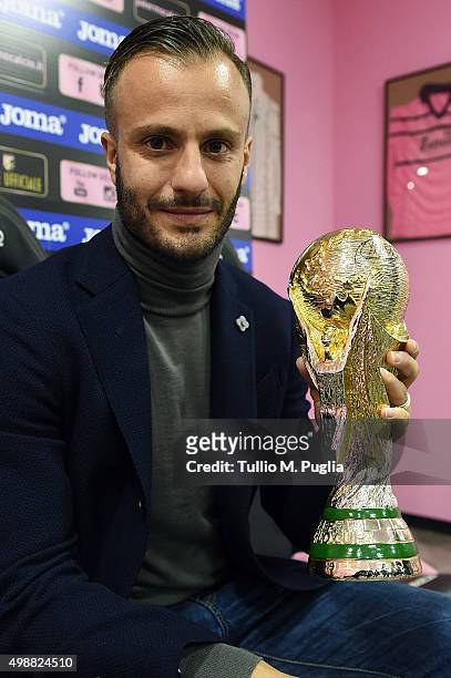 Alberto Gilardino of US Citta' di Palermo poses with a copy of FIFA World Cup Trophy after meeting supporters at Palermo Official Store on November...