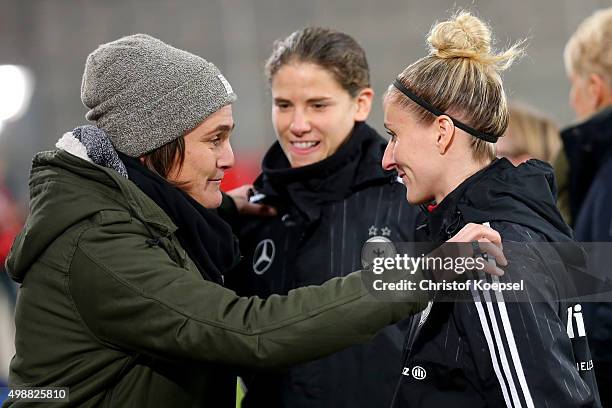 Nadine Angererm Annike Krahn and Anja Mittag of germany talk prior to the Women's International Friendly match between Germany and England at...