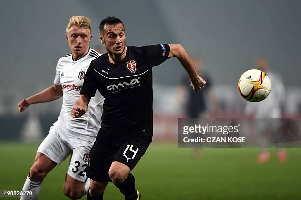 Skenderbeu's Albanian forward Hamdi Salihi challenges Besiktas' German defender Andreas Beck during the UEFA Europa League football match between...