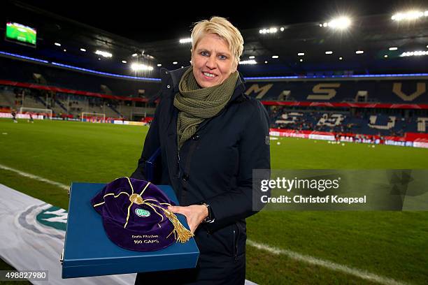 Fromer national player Doris Fitschen of Germany was honoured with more than 100 caps and poses with the cap prior to the Women's International...