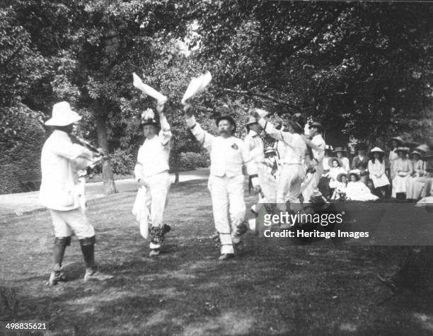 Bampton Morris Dancers, Oxfordshire, Whit Monday, 5 June 1911. William Nathan Wells playing the fiddle; Thomas Tanner and Joseph Rouse dancing....