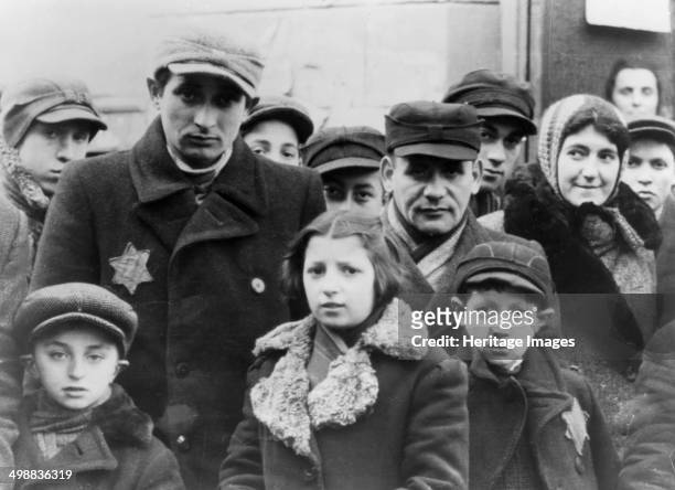 Jews wearing Star of David badges, Lodz Ghetto, Poland, World War II, 1940-1944. The Nazis forced Jews into over-crowded ghettos from which thousands...