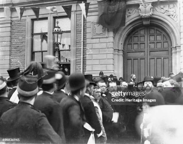 Crowd outside Buxton Town Hall, Derbyshire, c1900s. The black flag suggests that the crowd is waiting for an announcement, possibly Queen Victoria's...