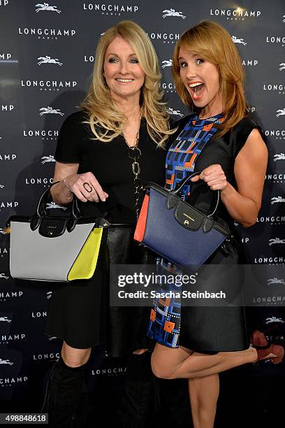 Frauke Ludowig and Mareile Hoeppner react during the Longchamp store opening on November 26, 2015 in Cologne, Germany.