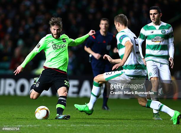 Lasse Schone of Ajaxhas his shot on goal charged down by Jozo Simunovic of Celtic during the UEFA Europa League Group A match between Celtic FC and...