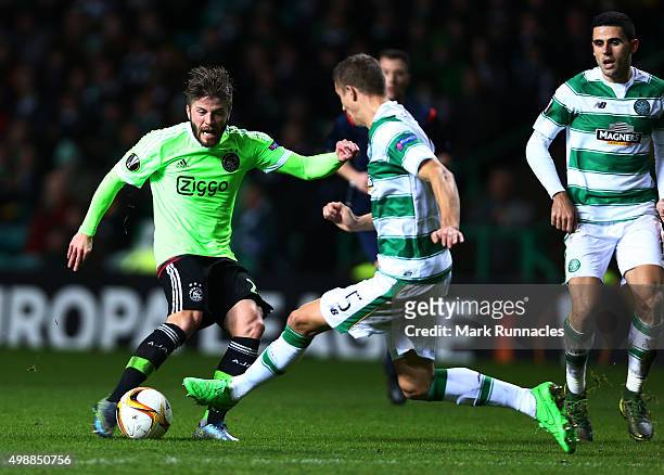 Lasse Schone of Ajaxhas his shot on goal charged down by Jozo Simunovic of Celtic during the UEFA Europa League Group A match between Celtic FC and...