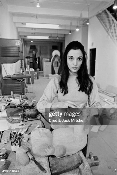 French-born scilptor Marisol Escobar at work in her studio, New York, New York, 1969.