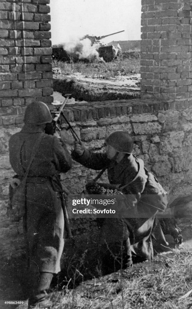 World War 2. Red Army soldiers with an anti-tank rifle, firing on a German tank on the Southwestern Front.