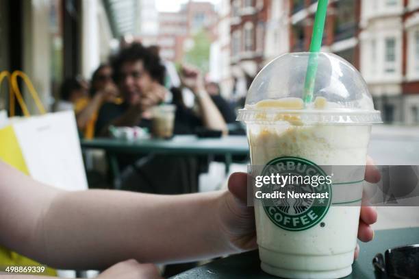 Woman drinking a Styarbucks Frappacihno.