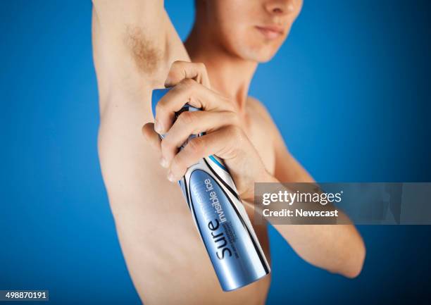 Illustrative image of a man using Sure for Men Invisible deodorant. A Unilever brand.