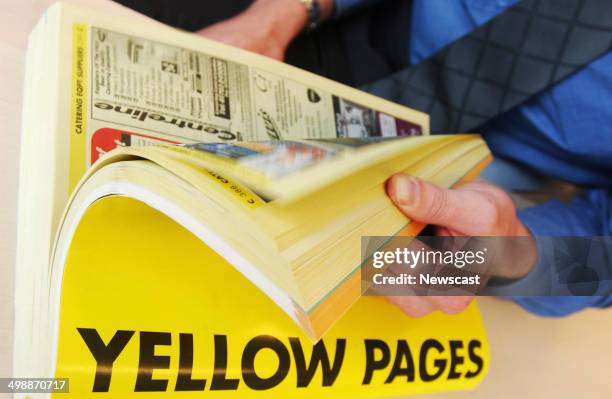 Man using the Yellow Pages telephone Directory.