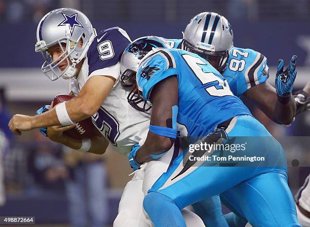 Tony Romo of the Dallas Cowboys is sacked by Thomas Davis and Mario Addison of the Carolina Panthers in the third quarter at AT&T Stadium on November...