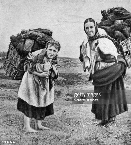 Historical Geography. 1900. Ireland. Clean to handle, cheap, and plentiful, peat is much appreciated by the Irish peasant women, two of whom, mother...