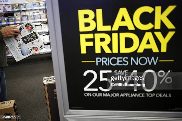 Shopper looks at a brochure at a Best Buy Co. Store ahead of Black Friday in Chesapeake, Virginia, U.S., on Thursday, Nov. 26, 2015. In 2011, several...