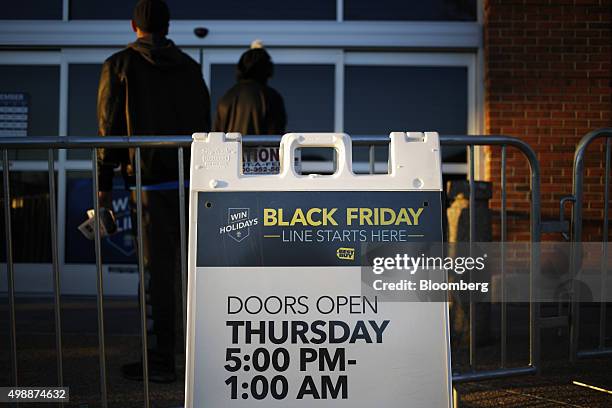 Signage provides opening hours information outside a Best Buy Co. Store ahead of Black Friday in Chesapeake, Virginia, U.S., on Thursday, Nov. 26,...