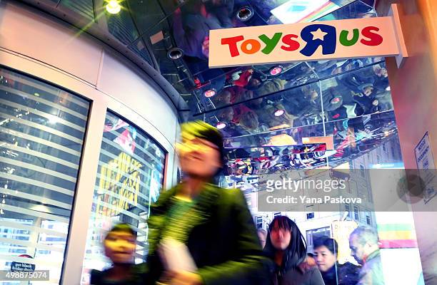 Customers wait in line to enter Toys R Us in Times Square on Thanksgiving evening for early Black Friday sales on November 26, 2015 in New York City....