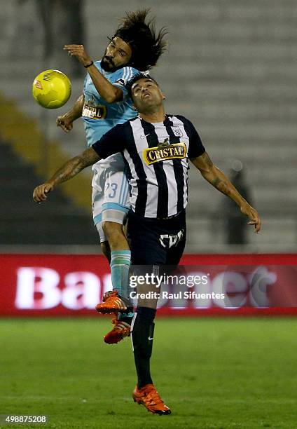 Jorge Cazulo of Sporting Cristal struggles for the ball with Pablo Miguez of Alianza Lima during a match between Alianza Lima and Sporting Cristal as...