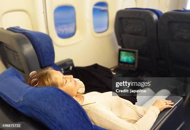 plane passenger sleeping - sitting back foto e immagini stock