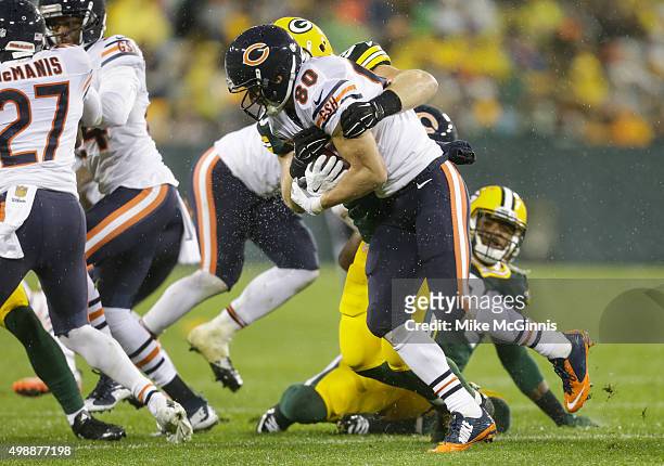 Marc Mariani of the Chicago Bears is hit by John Kuhn of the Green Bay Packers in the second quarter at Lambeau Field on November 26, 2015 in Green...