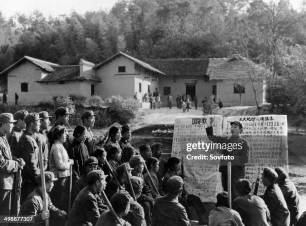 Cultural Revolution. Chinese workers singing revolutionary songs outside of Mao's home, Shaoshan Village in Shaoshan, Xiangtan, Hunan, China, late...