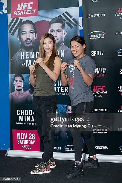 Julianna Pena and Octagon Girl, Yu Seung-Ok aka Seung Ok Yu pose for media before UFC Fight Night - Female MMA Class at CrossFit Sentinel IFC on...