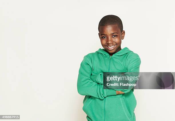 portrait of boy smiling - kids standing crossed arms stock-fotos und bilder