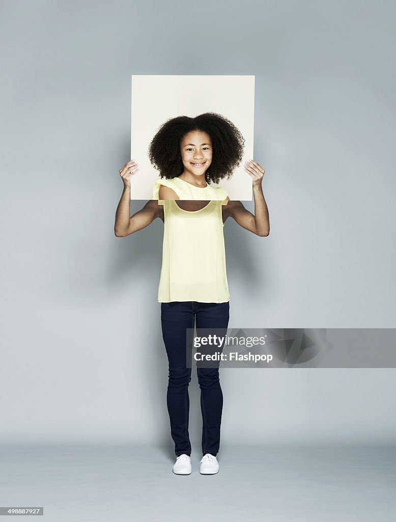 Woman holding portrait of herself as a child