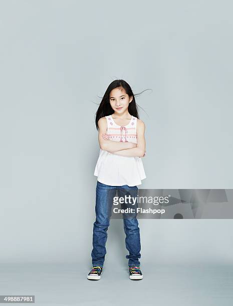 portrait of girl smiling - kids standing crossed arms stock-fotos und bilder