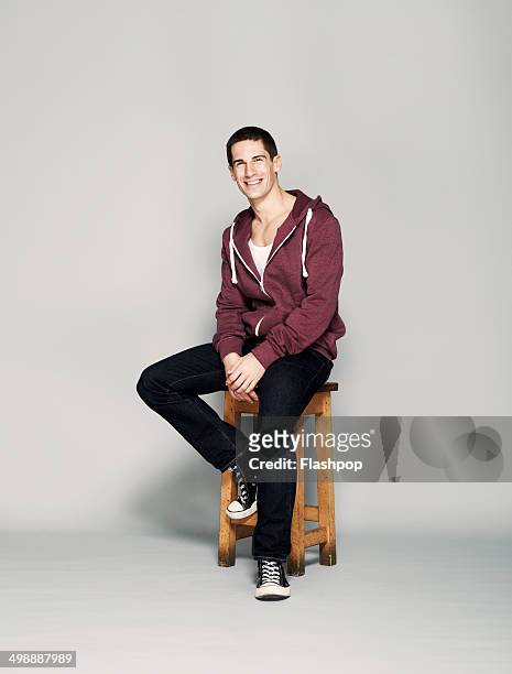 portrait of man smiling - stool stockfoto's en -beelden