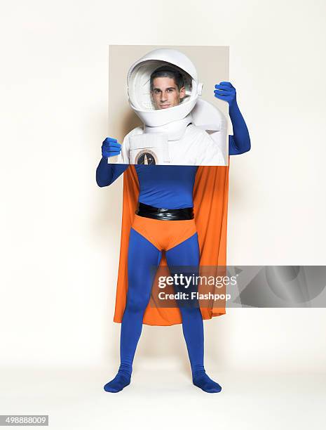 superhero holding picture of astronaut - superman reveal stock pictures, royalty-free photos & images