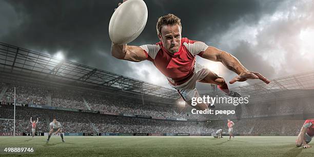 jugador de rugby buceo en mid aire por puntaje - rugby tournament fotografías e imágenes de stock