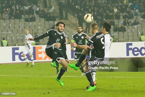 Badavi Guseynov and Maksim Medvedyev of Qarabag FK are challenged by Tottenham Hotspur FC players during the UEFA Europe League match between Qarabag...