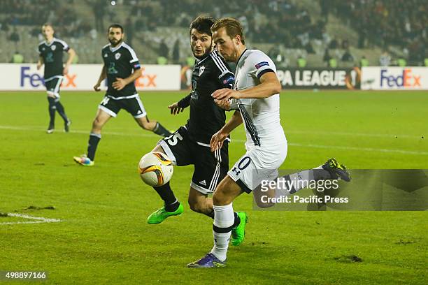 Badavi Guseynov of Qarabag FK is challenged by Harry Kane of Tottenham Hotspur FC during the UEFA Europe League match between Qarabag FK and...